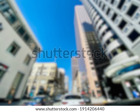 Abstract blur background wide angle view of street traffic and skyscrapers in downtown. ￼