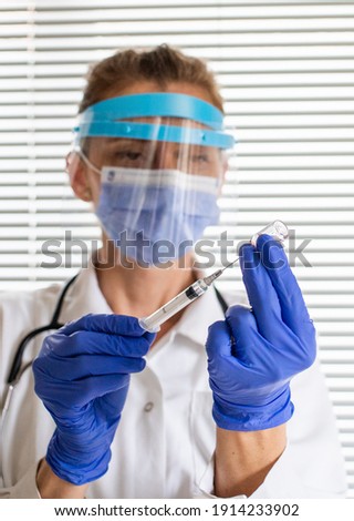 female doctor preparing to give coronavirus vaccine