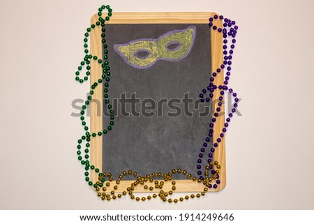 Mardi Gras chalk board with beads
