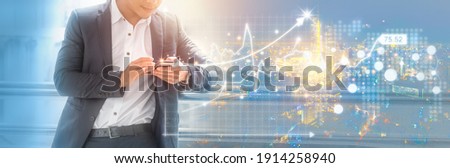Businessman using mobile phone analyzing sales data, economic graph chart and stock market. Panoramic banner of business technology with copy space