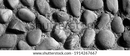 The cobblestone on the wall. Background texture(black and white photo)