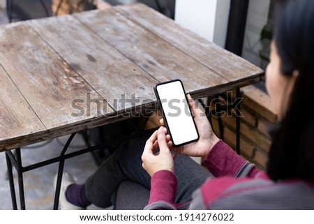 cell phone blank white screen mockup.woman hand holding texting using mobile on desk at office.background empty space for advertise.work people contact marketing business,technology 