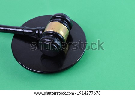 Judge gavel over green background. Selective focus