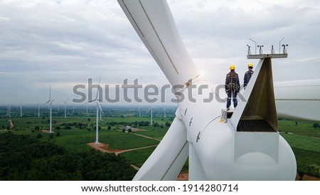
Inspection engineers standing on top of a wind turbine for Background Image. Royalty-Free Stock Photo #1914280714