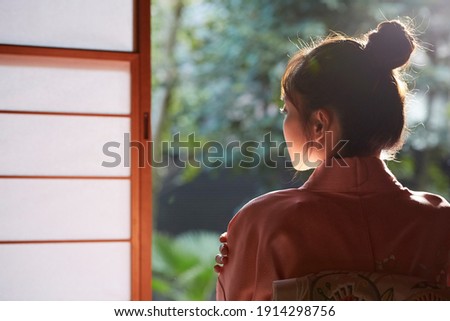 Portrait of a young Asian woman wearing Kimono at Japanese room Royalty-Free Stock Photo #1914298756