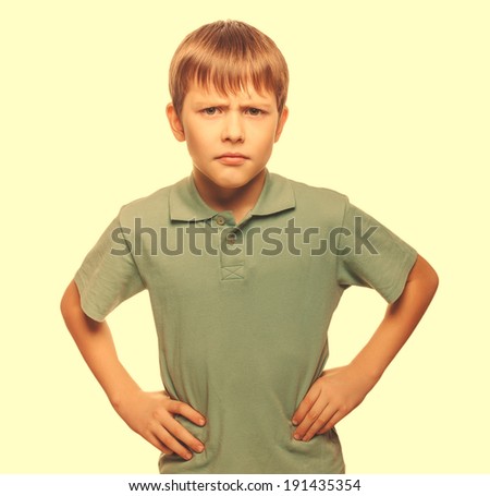 angry teen disgruntled teenager boy frowning isolated on white background large cross processing retro