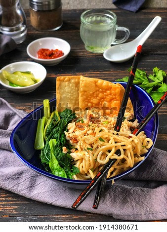 Cwiemie or Pangsit Mie, Malang style chicken noodle accompanied with fried wonton, clear broth and cucumber pickles.