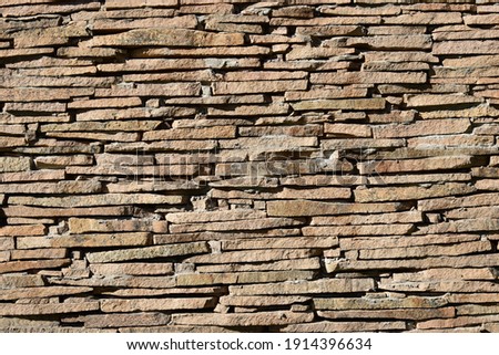 wall made of slate stones  to be used as background Royalty-Free Stock Photo #1914396634
