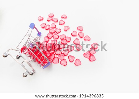 Valentine's day, endless love or special occasion concept : Top view of red hearts spilled out of a shopping cart. isolated on white background. copy space.