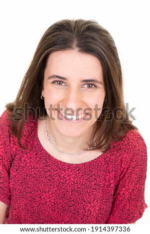 Pretty woman with long brunette hair dressed casually looking camera  isolated against blank studio background