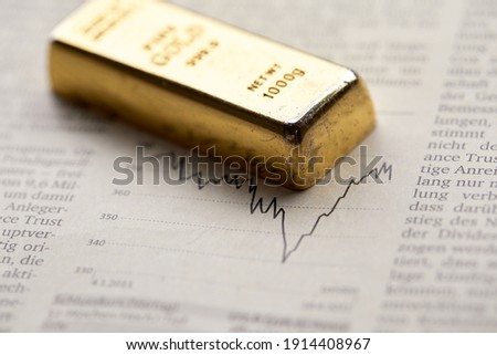 Gold bullion  on the graph as crisis safe haven, financial asset, investment and wealth concept.

