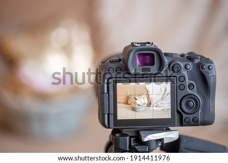 Close up professional digital camera on a tripod on a blurred background. The concept of technology for working with photos and videos.