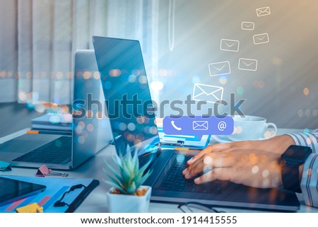 Contact us or Customer support hotline people connect. Businessman using a laptop computer with the (email, call phone, mail) icons. Royalty-Free Stock Photo #1914415555