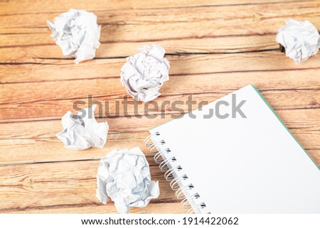 Paper balls and pen over blank white sheet - Creativity crisis concept
