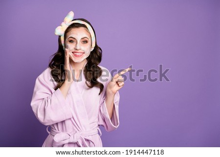 Photo portrait of cute surprised girl with face mask showing empty space smiling with headband isolated on bright purple color background