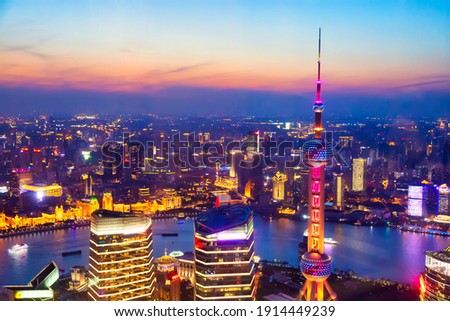 Aerial cityscape of Shanghai at sunset. Panoramic view of Pudong business district skyline from the skyscraper.