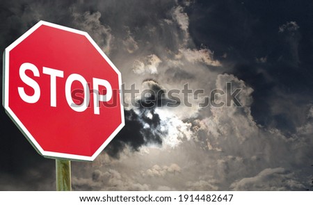 Conceptual stop sign with stormy background. Danger sign