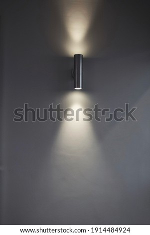 An uplight downlight illuminating a wall. Royalty-Free Stock Photo #1914484924