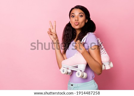 Profile side photo afro american pretty woman make v-sign wear roller skates send air kiss copyspace isolated on pink color background