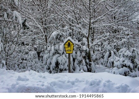 nature reserve sign in snow covered forest