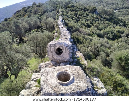 Ruins of Delikkemer Roman Aqueduct. View Delikkemer Bridge. Near to Patara Ancient City at location Kalkan, Kas, Antalya Royalty-Free Stock Photo #1914500197