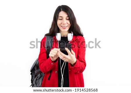 Happy young student girl using smartphone.