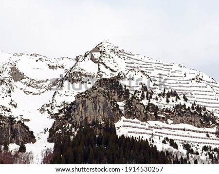 Snowy alpine mountain massif Mattstogg during winter in the Swiss Alps and over the Lake Walen or Lake Walenstadt (Walensee), Amden - Canton of St. Gallen, Switzerland (Schweiz)