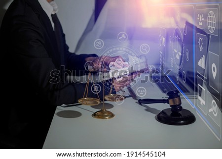 Law and Legal services concept, Lawyer man working with digital tablet  at the table office and law technology interface icons, Blurred background.