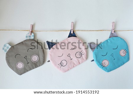 Cute handmade cat and bear pouches over white