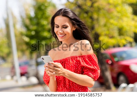 Photo of young attractive woman hold phone addicted user social median urban life outside in city outdoors