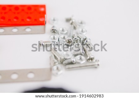 a children's iron constructor with nuts and screws on a white background