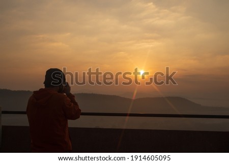 A photographer taking a picture in the morning of northern Thailand.