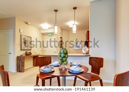 Modern apartment with open floor plan. View of served dining table in dining area