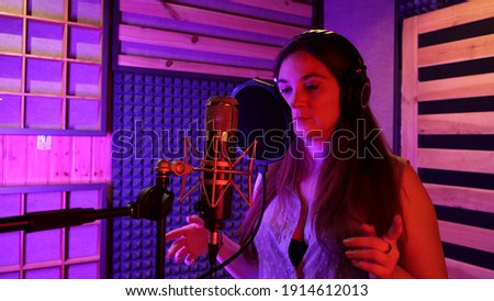 music group rehearsing, testing vocals and mastering in a professional recording studio
