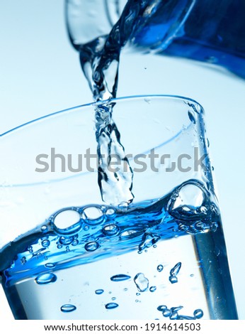 Close-up picture of a pouring water into a glass.