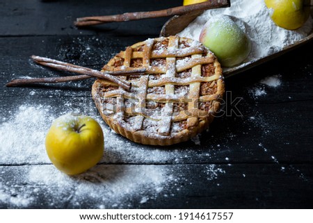 Apple pie with cinnamon on an old textured wooden background