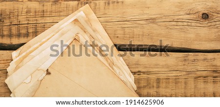 Sheets of old vintage paper on a wooden table. Copy space. High quality photo