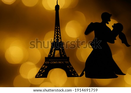 silhouette of  Eiffel Tower  at evening sunset light. isolated on bokeh background. Paris France. night scene. couple in love dancing tango. 
