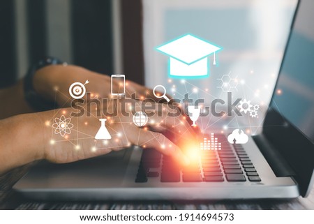 E-learning concept. Hand typing keyboard of laptop with virtual education icon. Digital learning interface innovation.  Royalty-Free Stock Photo #1914694573