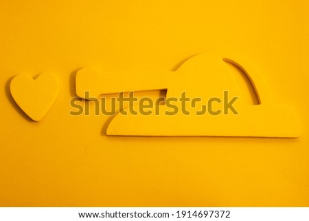 Creative idea of a heart on a yellow background under sight. The concept of love