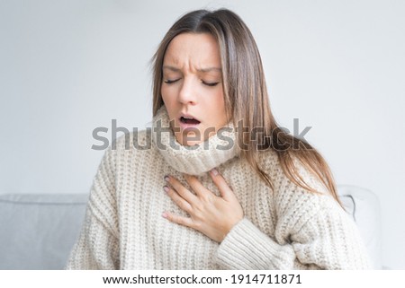 Woman having breath difficulties. Shortness of breath. Coronavirus cough breathing problem Royalty-Free Stock Photo #1914711871