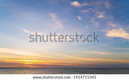 Sunset Horizon Sky over sea in the Evening with Romantic colorful Orange sunlight cloud, Dusk sky background  Royalty-Free Stock Photo #1914715345
