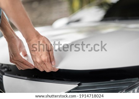 Close up of hands being open the car hood or bonnet for maintenance checking engine  before a trip or journey, Car check condition concept. Royalty-Free Stock Photo #1914718024