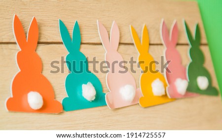 Easter rabbits on a wooden background. Banner. DIY holiday handicraft decorations. Concept: children's crafts for Easter. Top view.