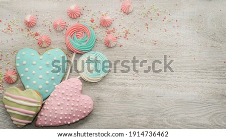  Easter cooking baking background with pastel colored easter cookies and meringue. Wooden rustic background, flatlay banner copy space. Happy Mothers Day. Happy Birthday card.                         