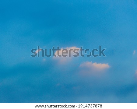 Defocused image of white cloud in blue sky.