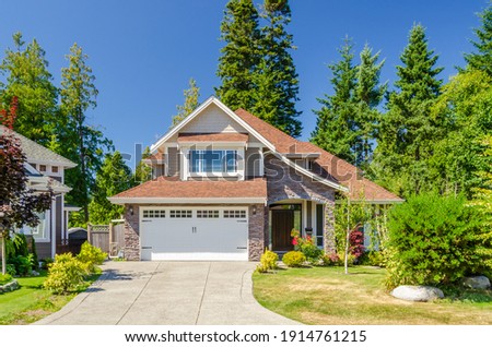 A perfect neighbourhood. Houses in suburb at Summer in the north America. Luxury houses with nice landscape. Royalty-Free Stock Photo #1914761215