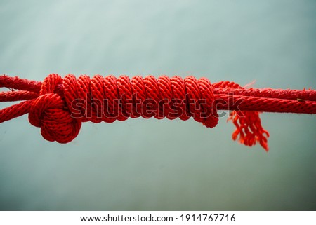 Rede knot against,Rope of red color