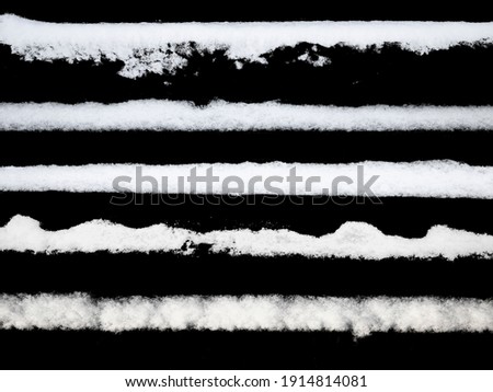 set of strips of white snow isolated on a black background. High quality photo Royalty-Free Stock Photo #1914814081