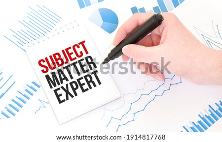 Businessman holding a black marker, notepad with text SUBJECT MATTER EXPERT,business concept